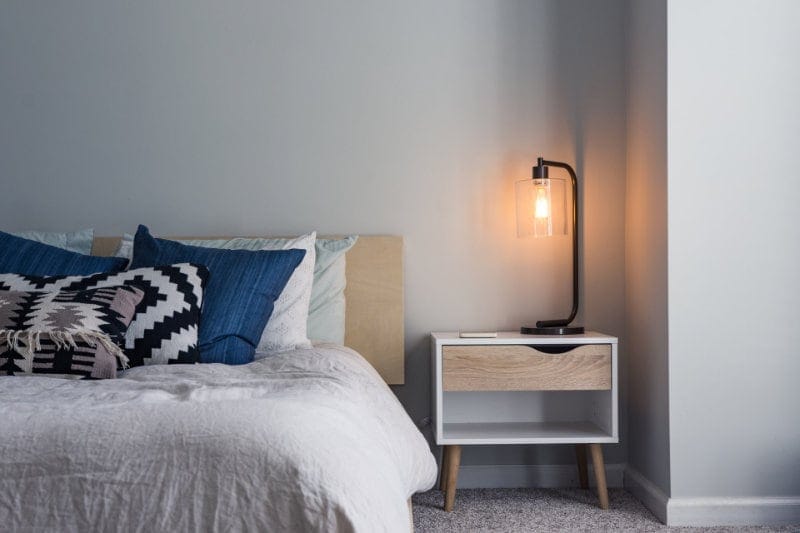 Room with black table lamp on nightstand